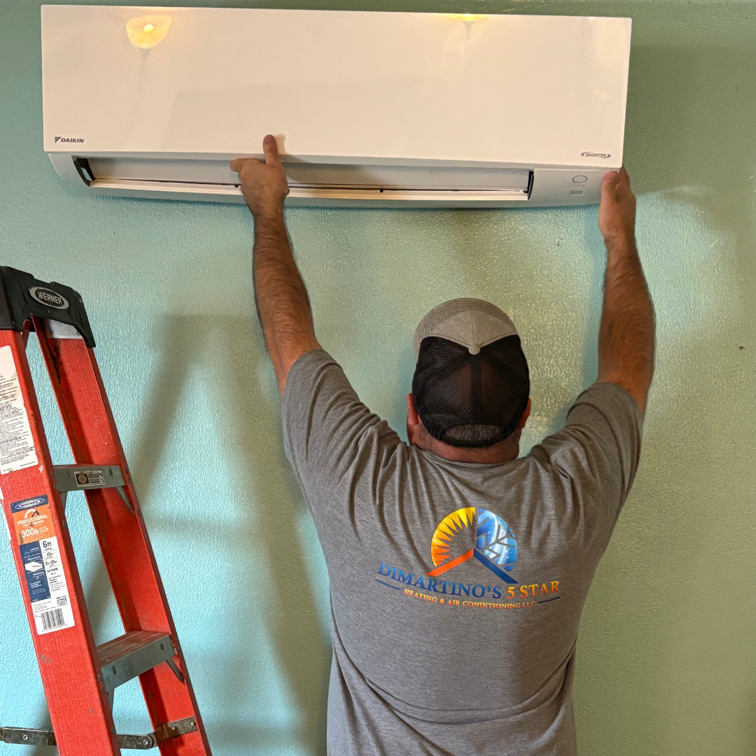 Professional technician installing Daikin ductless mini split air conditioning system on wall in Salem Oregon home