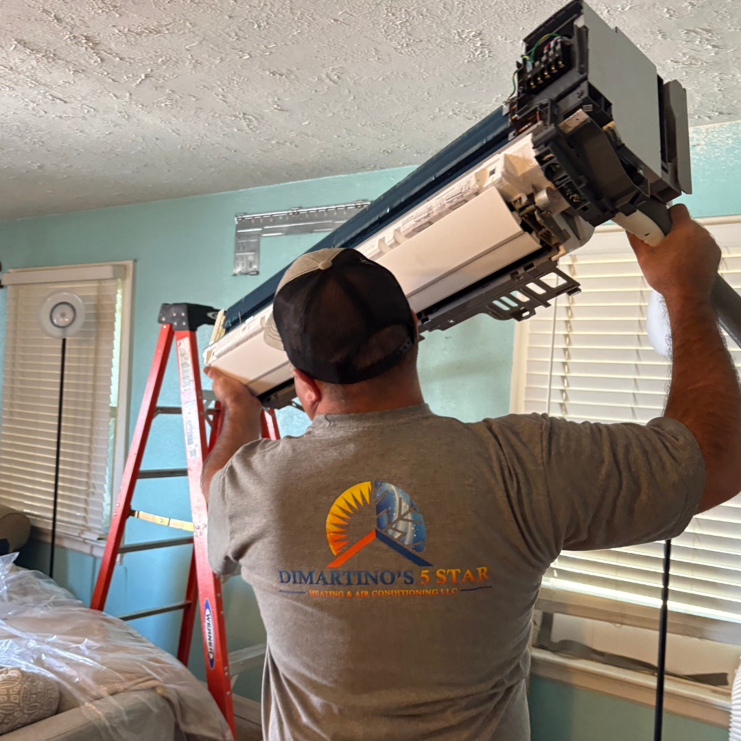 DiMartino's technician installing indoor ductless mini split unit with precision and care