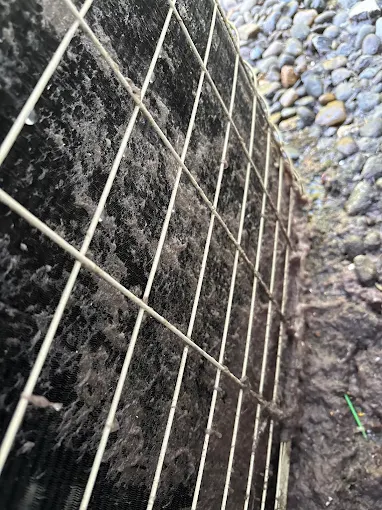 Proper system ventilation and access points for professional AC maintenance and repair Foundation access grating showing proper HVAC system ventilation and maintenance access for AC repair in Salem Oregon